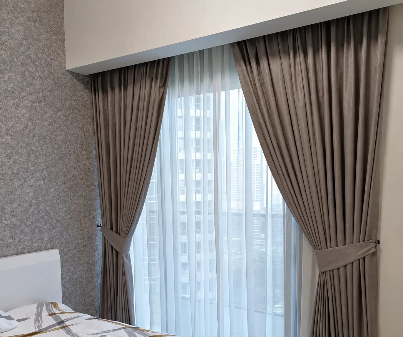 Blackout curtains with tiebacks over a sheer