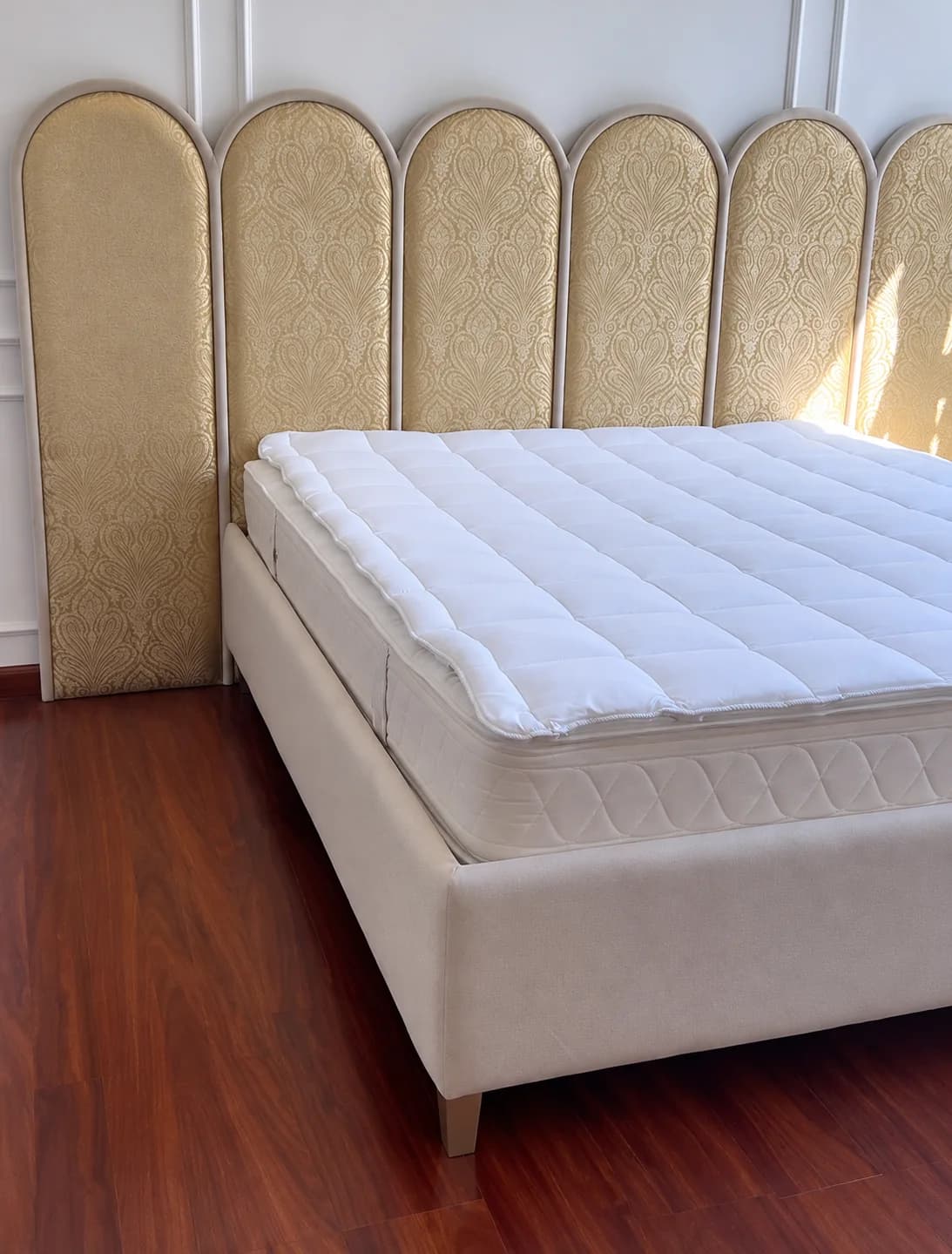 Upholstered wall panels behind a bed