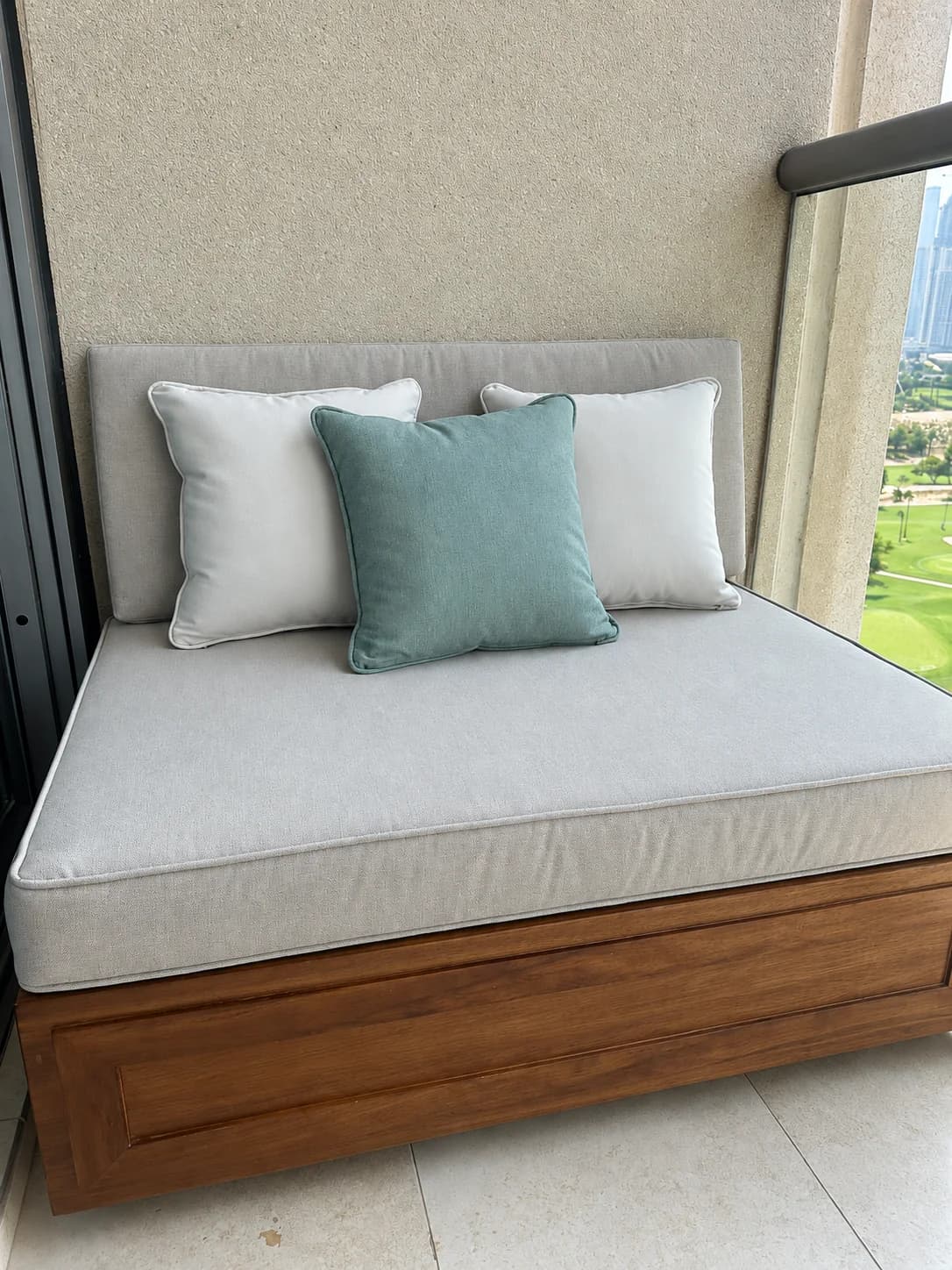 A cushioned daybed by the window
