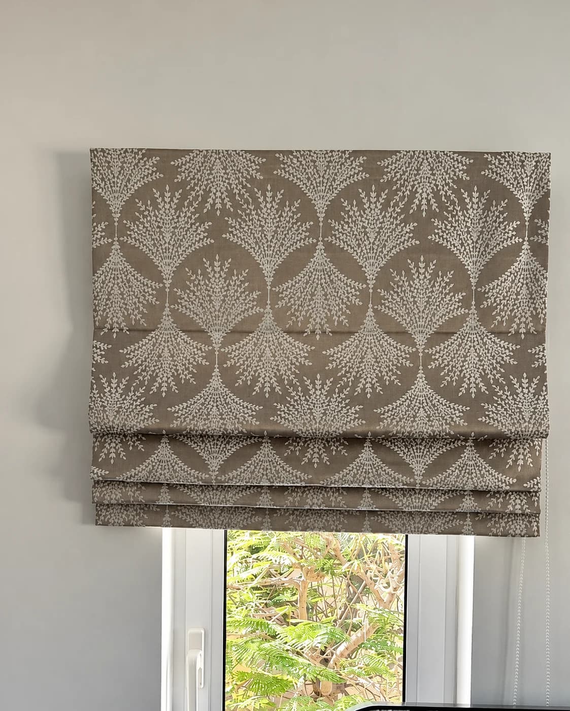 A Roman blind in a patterned fabric