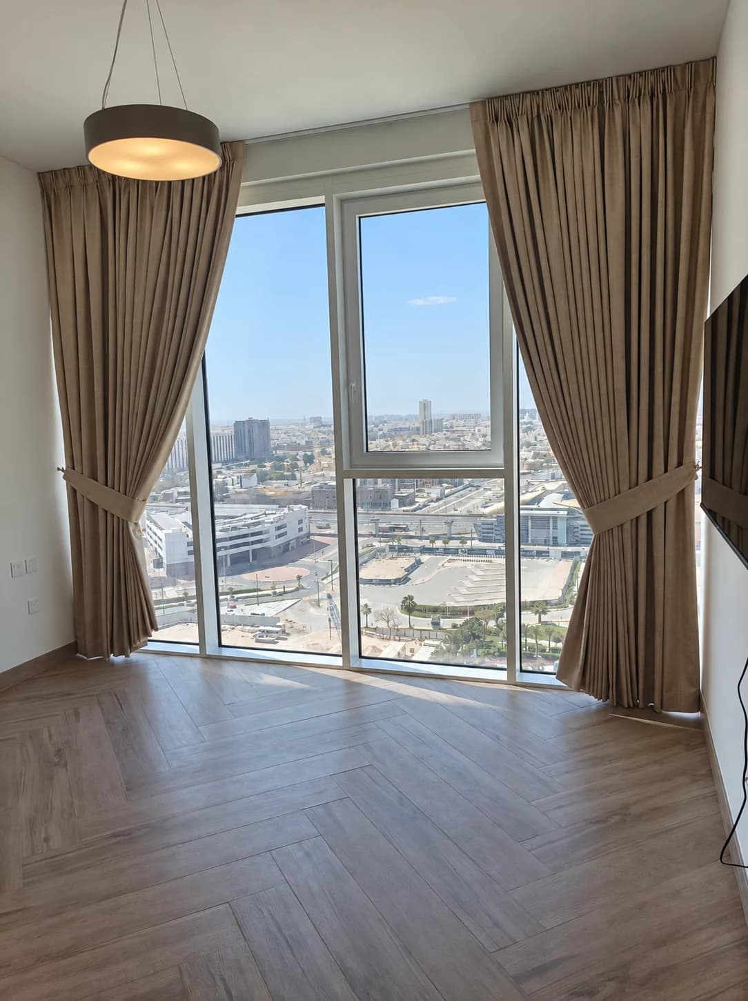 Taupe drapes framing a city view