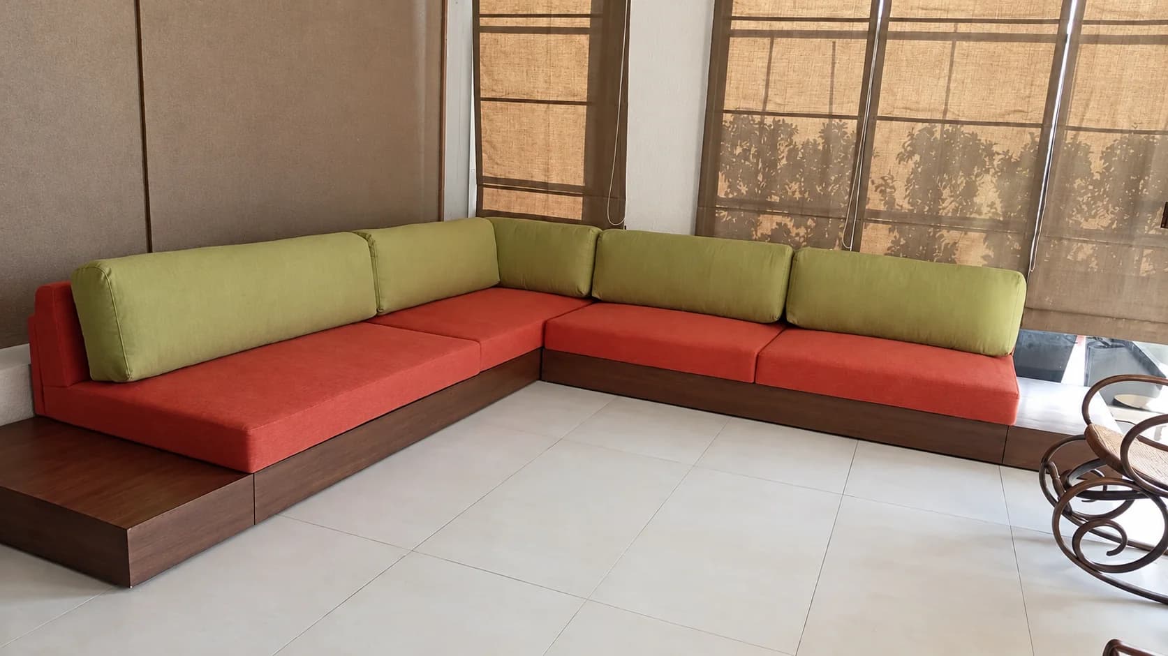 A coral and lime corner sofa on a wooden base