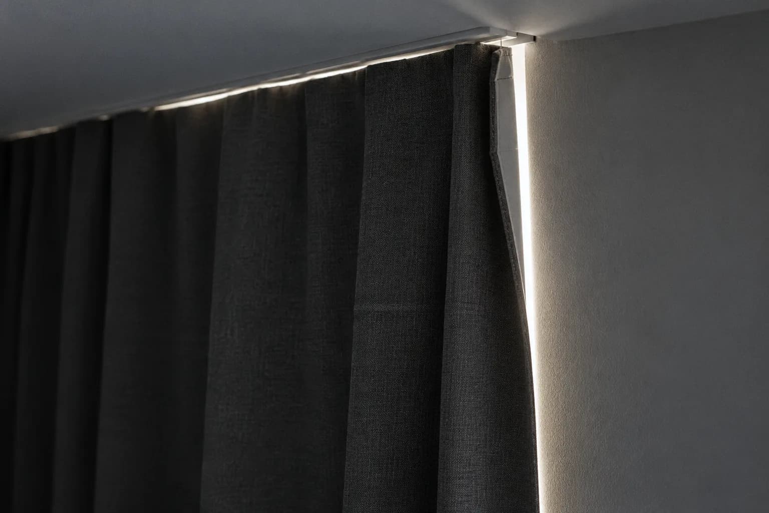 Daylight leaking down the edge of a closed blackout curtain