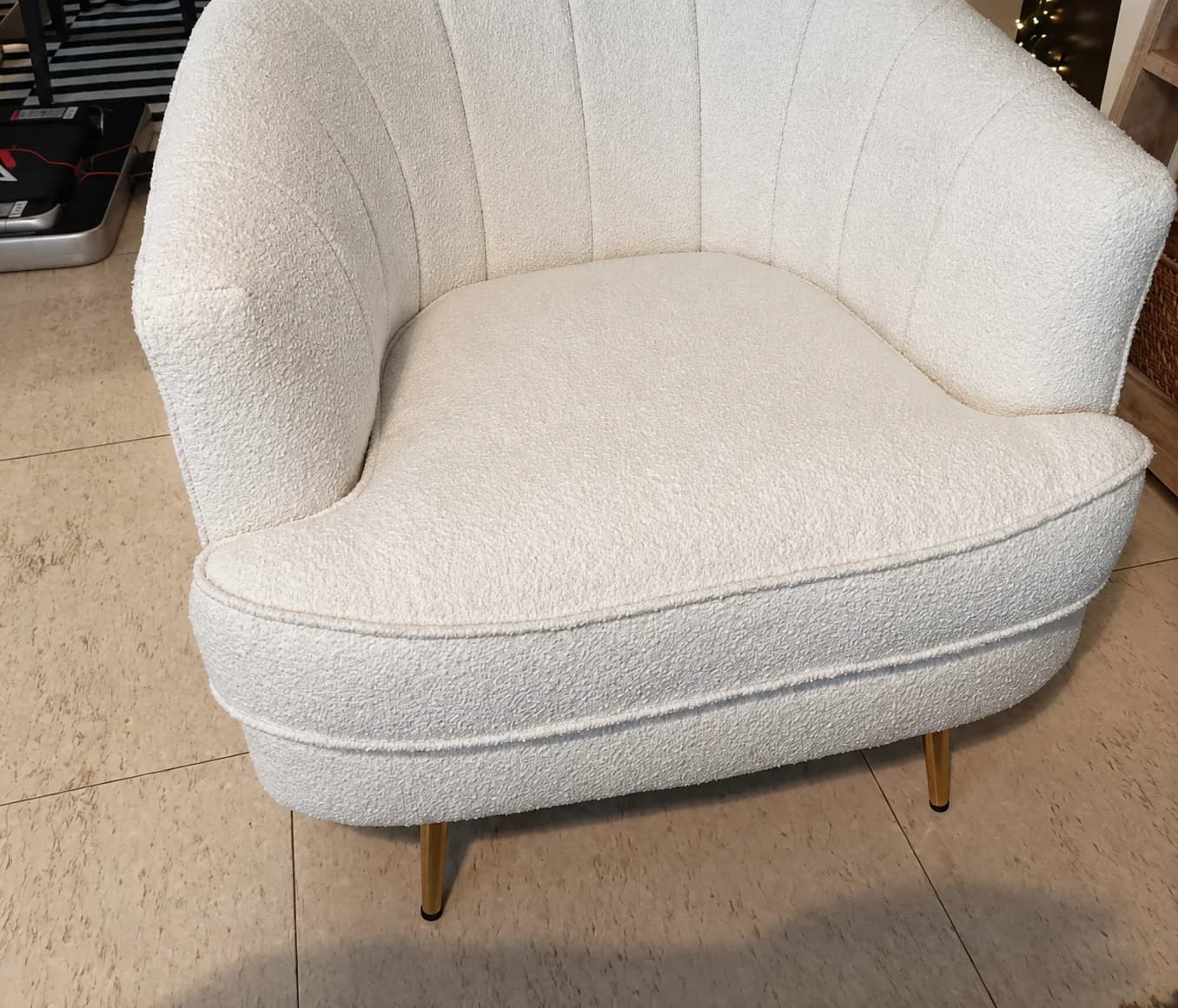 A white armchair in a textured fabric